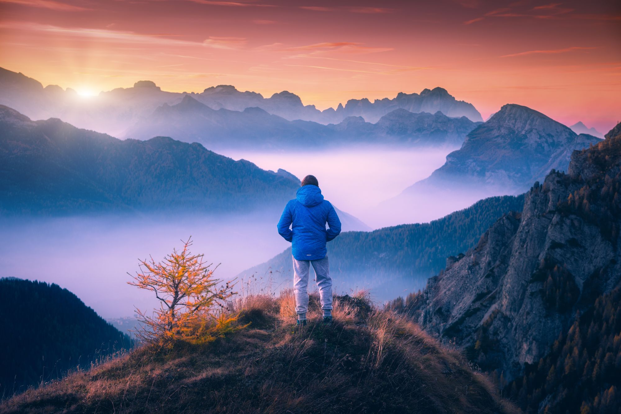 Hiker watching sunset in mountains